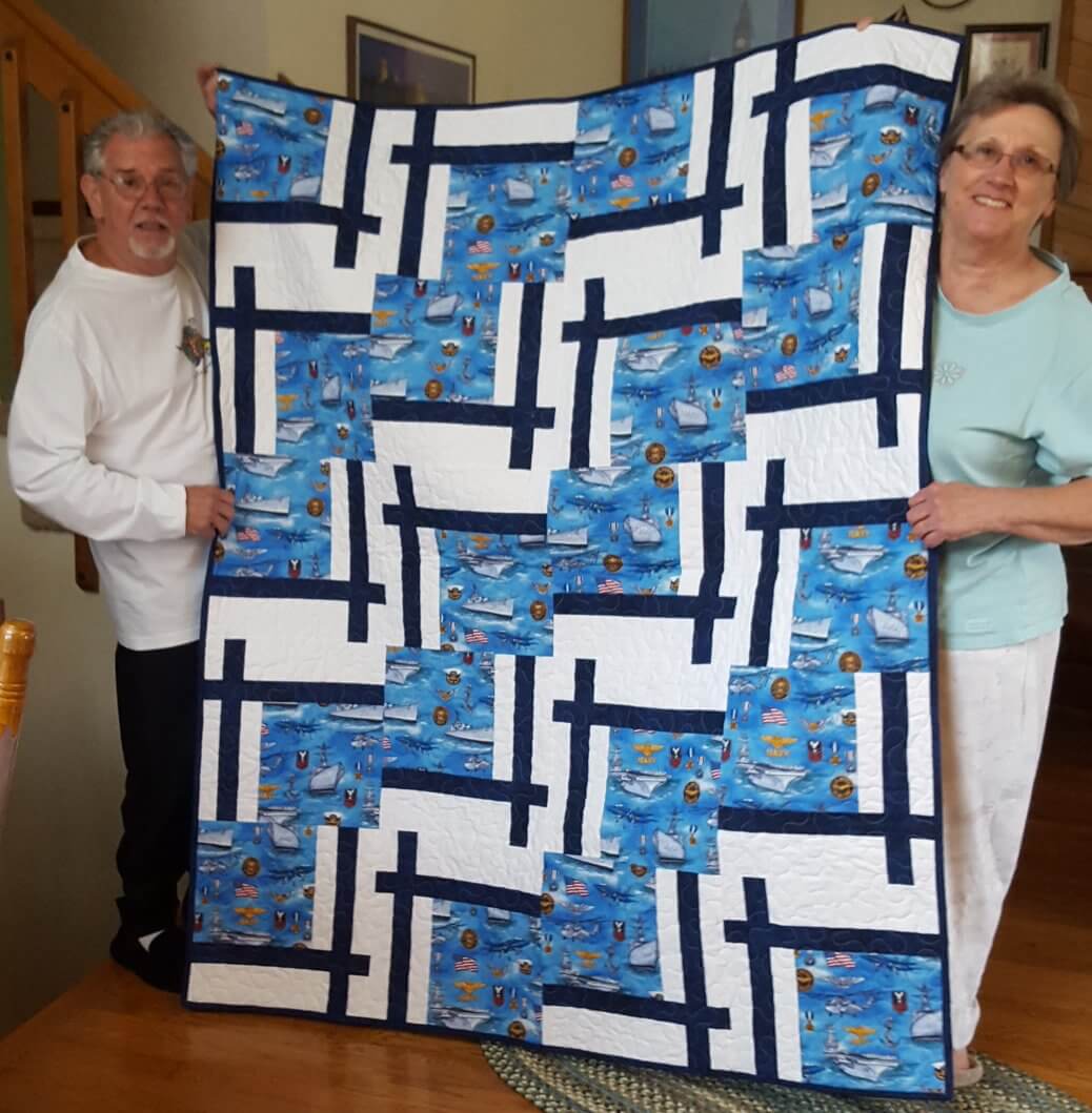 Sue created this QOV for someone special. Crisp navy and white is always a winter. 20 – 13 ½” blocks  54” x 67.5”.